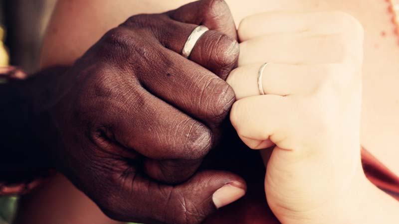 Close up of a man and woman holding hands