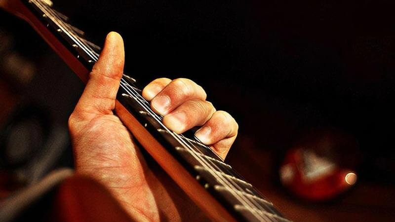 Close up of man playing an acoustic guitar