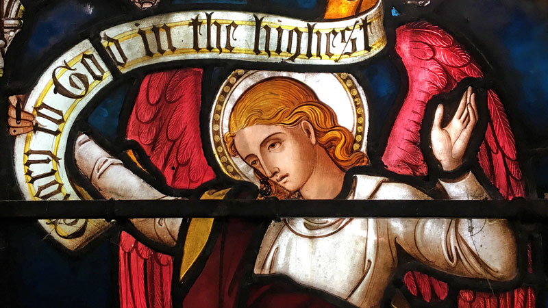 Detail of St James church stained glass window showing an angel