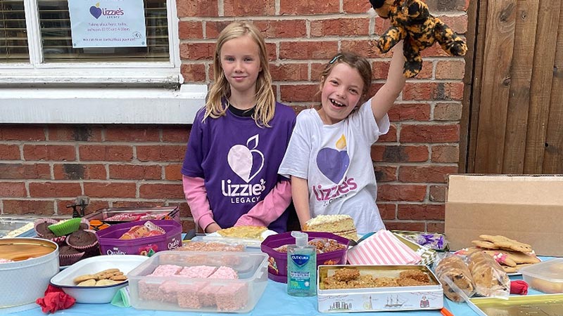 Daisy and her cousin at the cake stall