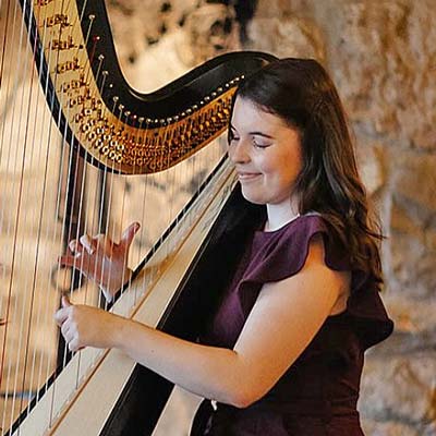 Angharad Huw playing a harp