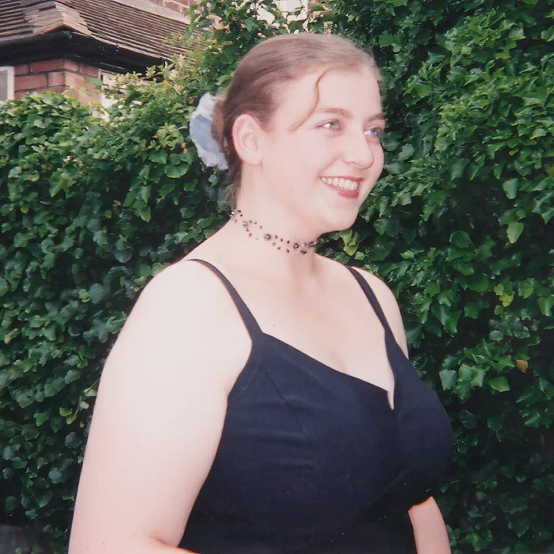 Rosalind is in the garden wearing a dark blue evening dress
