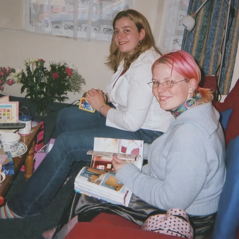 Rosalind and a friend sitting on a settee in the lounge
